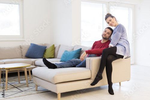 couple hugging and relaxing on sofa