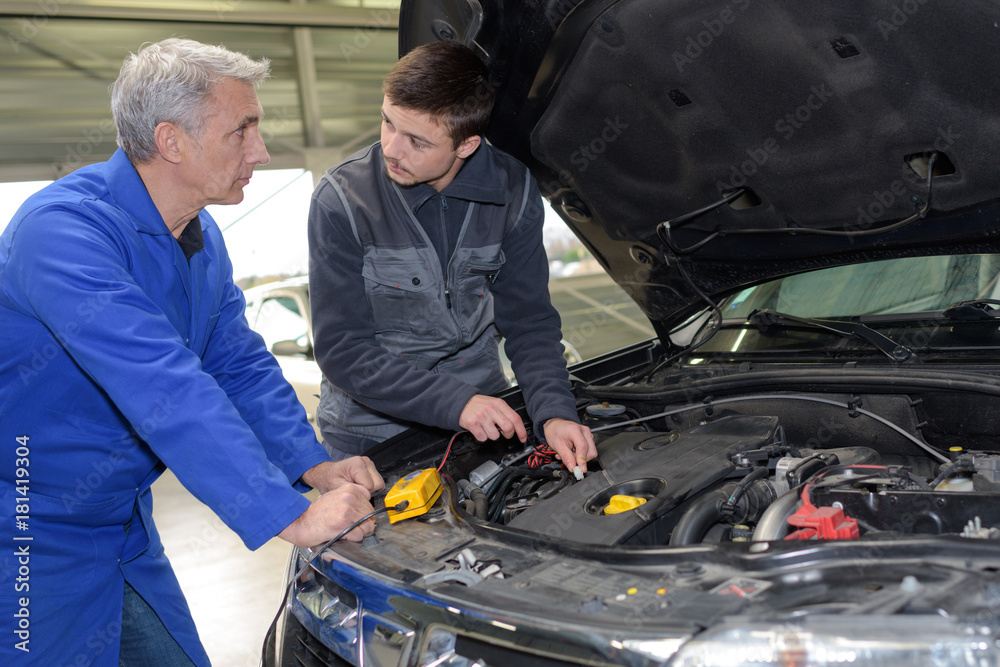 student mechanic learning from teacher in automotive vocational school student mechanic learning from teacher in automotive vocational school