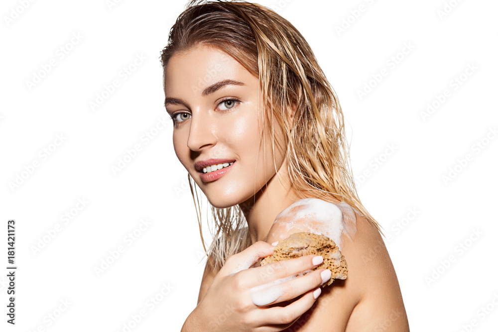 Portrait of beautiful woman with soap foam on her shoulder. Happy smiling woman portrait isolated on white. Body care and cosmetology concept. Image for advertising skin care products. Portrait of beautiful woman with soap foam on her shoulder. Happy smiling woman portrait isolated on white. Body care and cosmetology concept. Image for advertising skin care products.