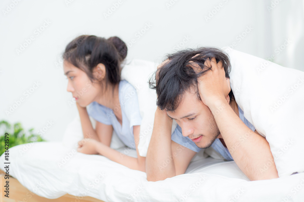 Relationship difficulties, conflict and family concept - unhappy couple having problems at bed - lover with conflict and stress on bedroom.