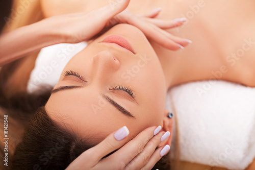 Beautiful Young Woman Getting a Face Treatment at Beauty Salon.