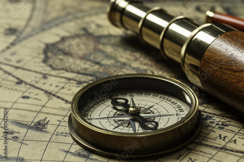 Retro compass with old map and spyglass