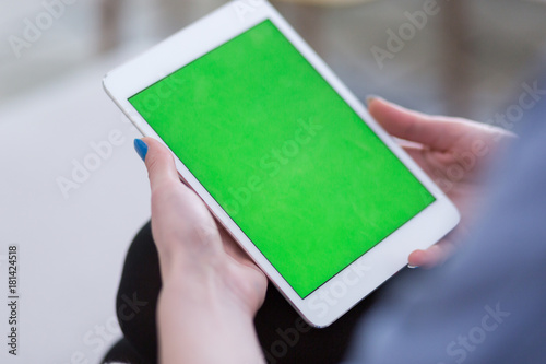 woman on sofa using tablet computer