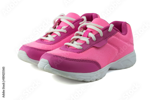 Womens pink sneakers with white laces isolated on white background.