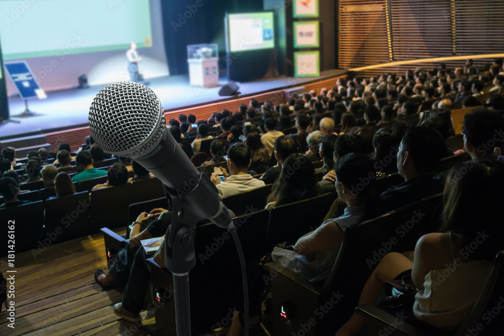 Microphone with Abstract blurred photo of conference hall or meeting room with attendee background, business and education concept