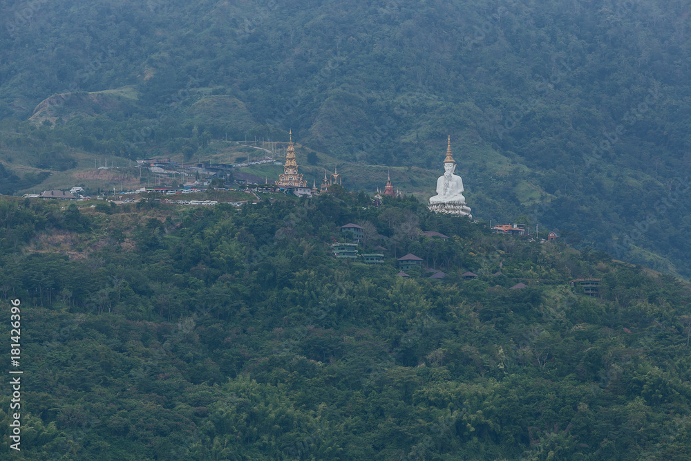 White big buddha aerial view with mountain background at Wat Prathat Phasornkaew, Khao Kho, Phetchabun, Thailand