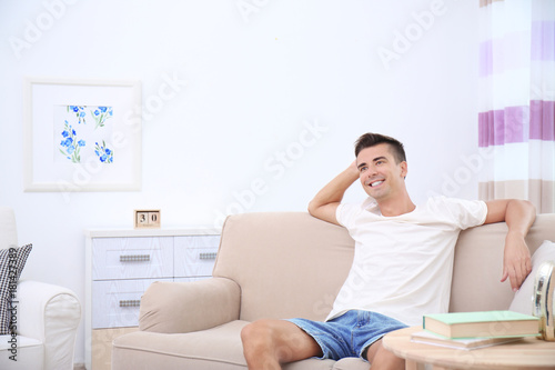 Relaxed young man sitting c...