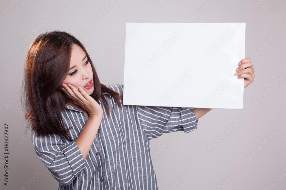 Young Asian woman surprise with white blank sign. Young Asian woman surprise with white blank sign.