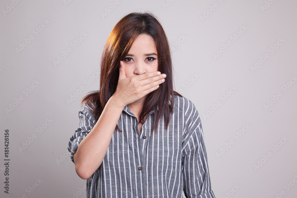 Young Asian woman close her mouth with hand. Young Asian woman close her mouth with hand.