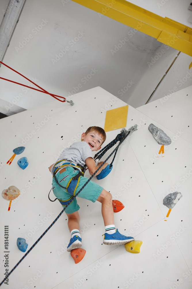 Child climbing on a high wall Child climbing on a high wall