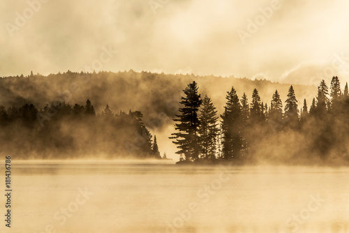 Lake of two rivers algonquin national park ontario canada sunset sunrise with fog foggy mystical atmosphere background photo