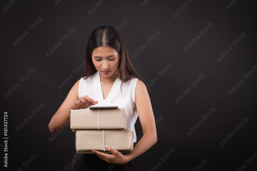 woman shopping online with tablet, holding parcel delivery box woman shopping online with tablet, holding parcel delivery box
