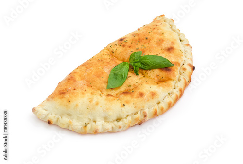 Cooked calzone with basil twig on a white background