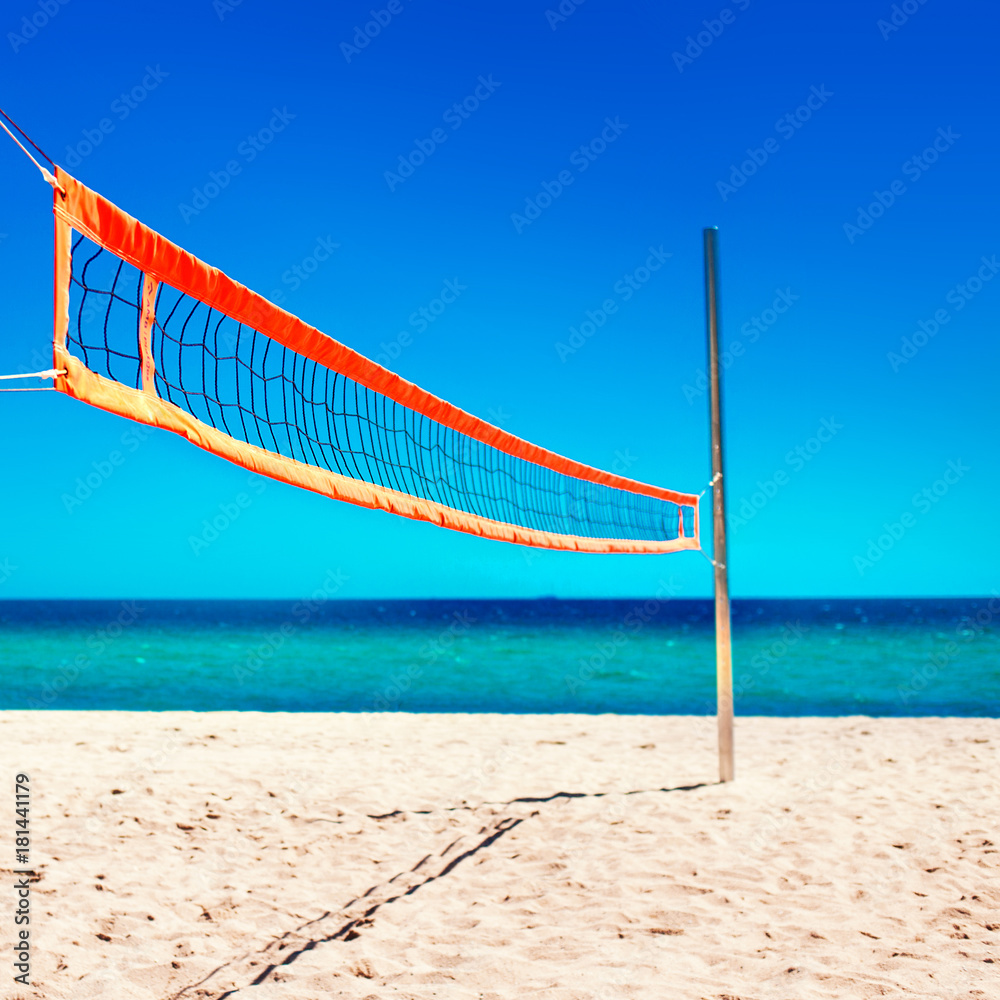 Volleyball net and empty beach. Sea Beach and Soft wave of blue ocean. Summer day and sand background. . Volleyball net and empty beach. Sea Beach and Soft wave of blue ocean. Summer day and sand background. .