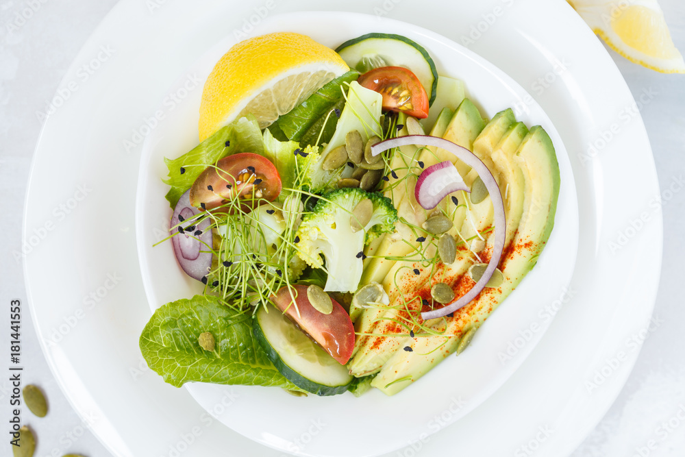 Healthy vegetable salad with avocado, broccoli, sprouts and tomatoes. Healthy vegetable salad with avocado, broccoli, sprouts and tomatoes.