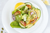 Healthy vegetable salad with avocado, broccoli, sprouts and tomatoes.