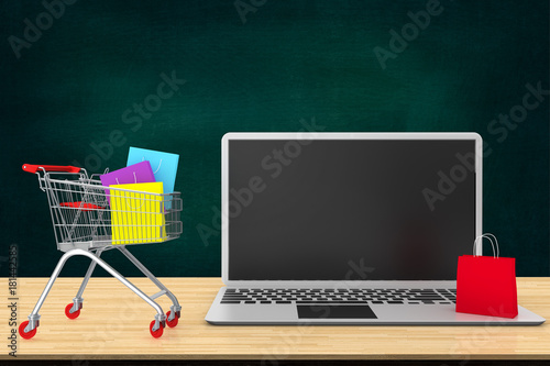 Online shopping and delivery service concept.Paper bags in shopping cart on wood table with laptop keyboard.Ideas about online shopping that customer order things from retailer sites via the internet.