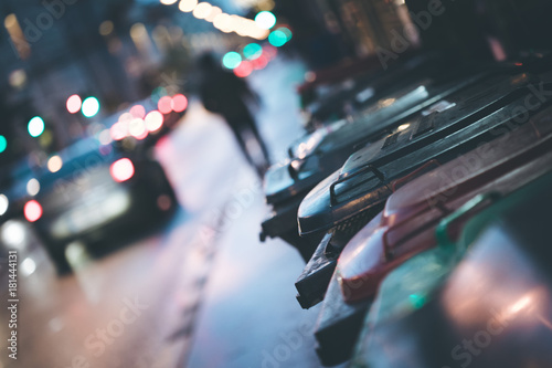 Abfalltonnen am Straßenrand, Abend und unscharfe Autos/Stau