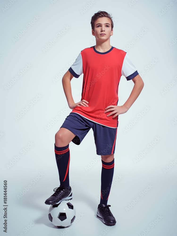Photo of teen boy in sportswear holding soccer ball Photo of teen boy in sportswear holding soccer ball