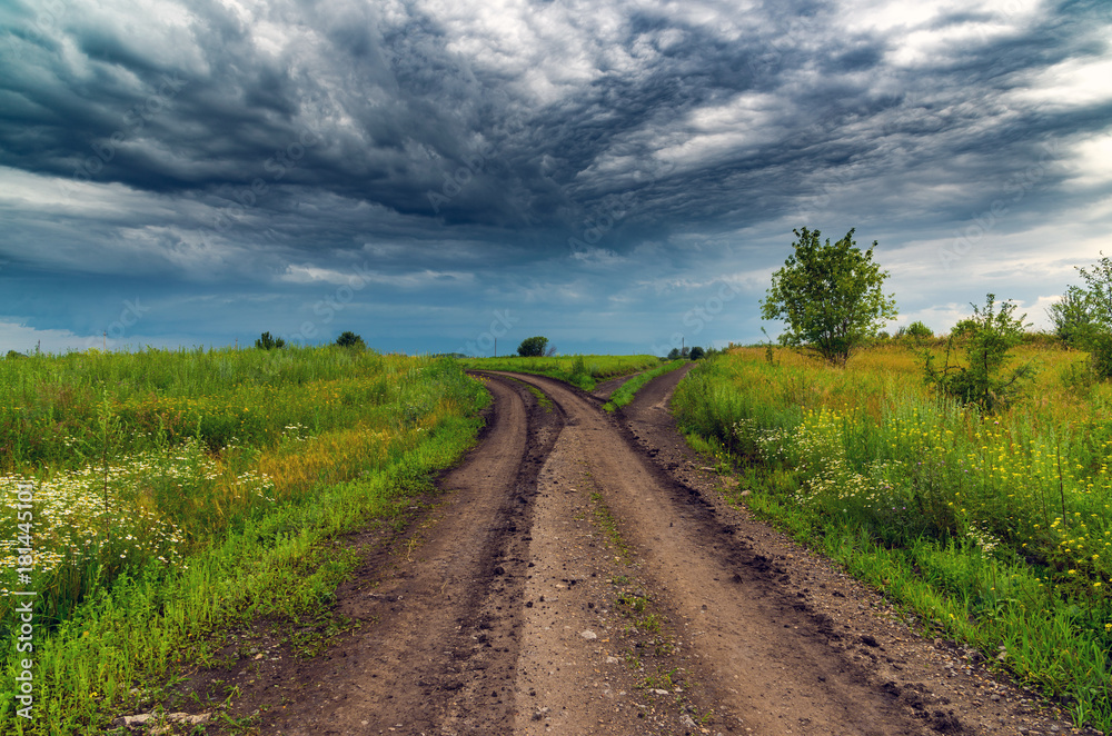 rural landscape with road and a stormy sky