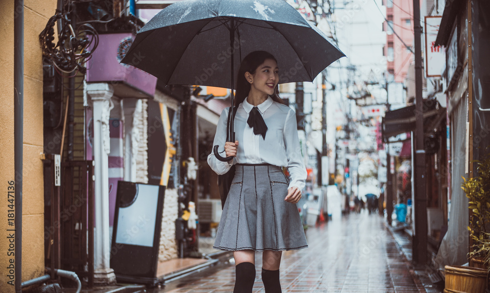 Fototapeta premium Beautiful japanese girl walking in Tokyo. Concept about teenagers and school