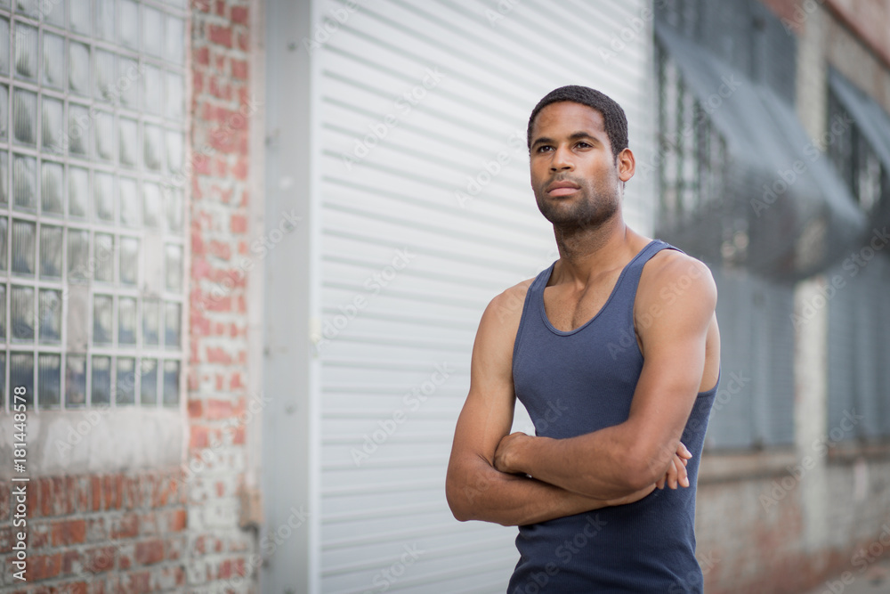 Young handsome African American man with arm crossed in the rough neighborhood Young handsome African American man with arm crossed in the rough neighborhood