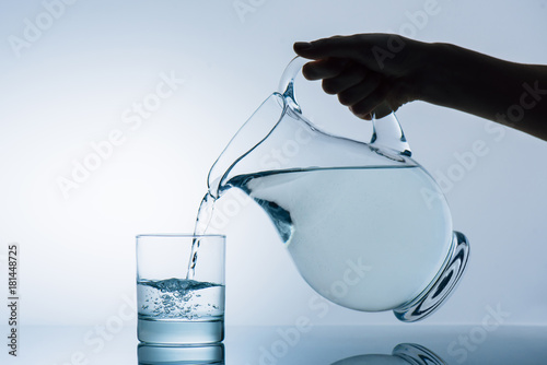 woman pouring water from jug