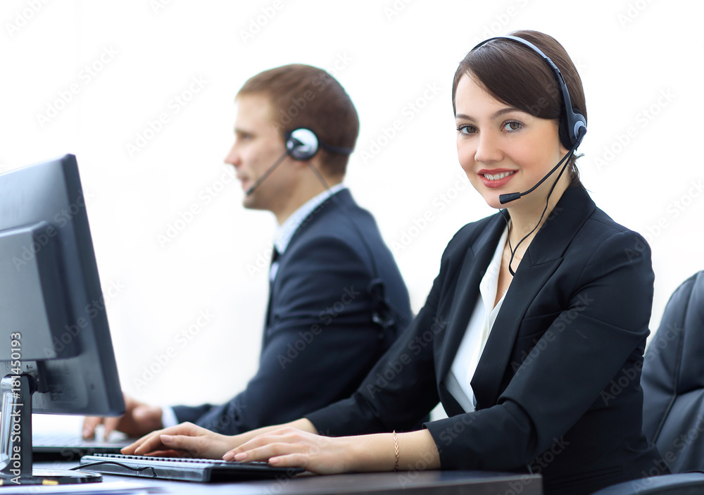 Female Customer Services Agent With Headset Working In A Call Center Female Customer Services Agent With Headset Working In A Call Center