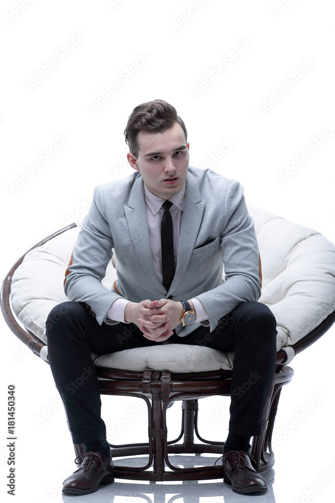 tired businessman sitting in a round chair made of rattan tired businessman sitting in a round chair made of rattan