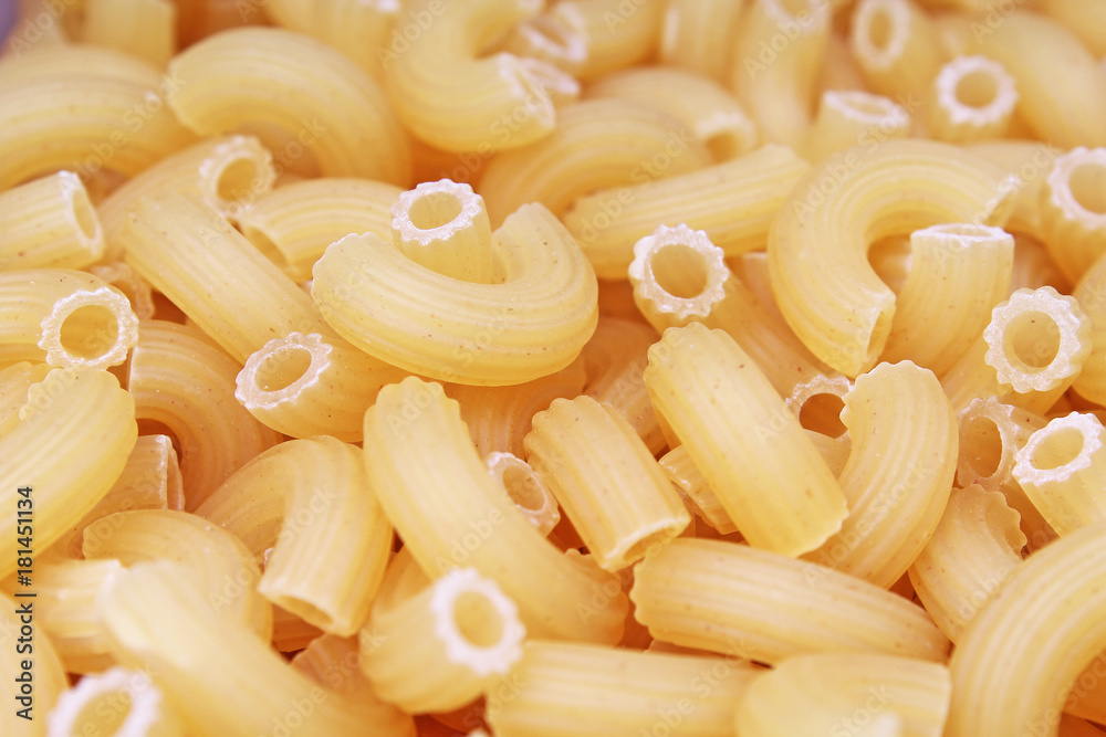 Macaroni dry pasta background concept. Pasta texture for background uses. Swirled pasta pattern. Food photography in studio. Raw. Macaroni dry pasta background concept. Pasta texture for background uses. Swirled pasta pattern. Food photography in studio. Raw.
