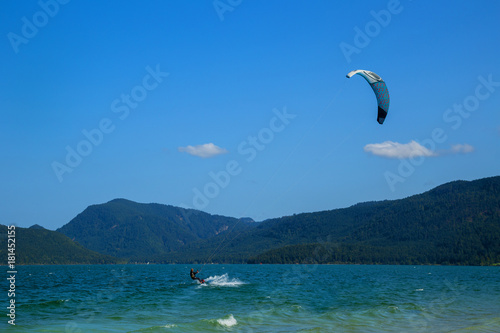 Kitesurfing on Walchensee with beautiful view towards the Bavarian Alps in Germany