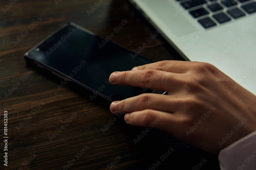 Office, work, hand holds phone, laptop, desktop Office, work, hand holds phone, laptop, desktop