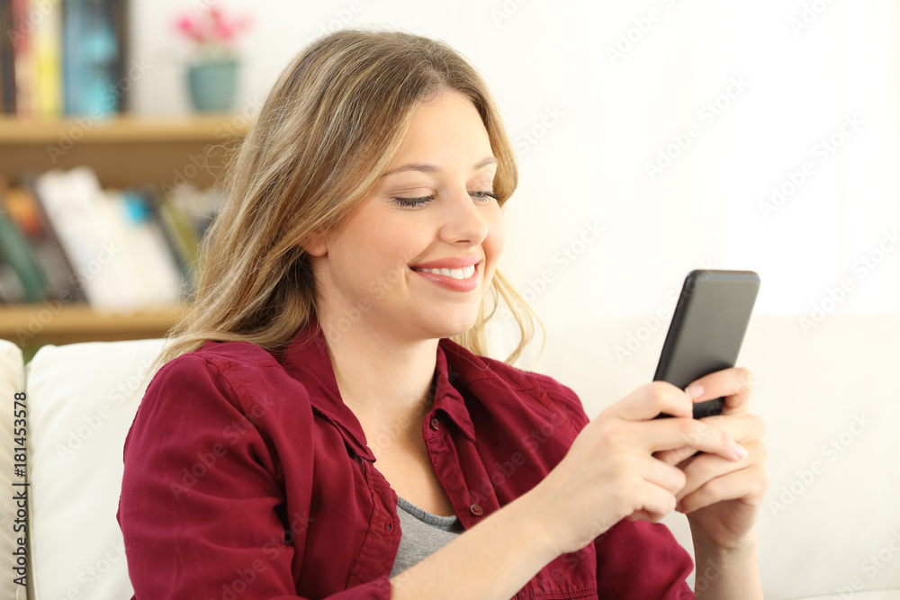 Happy woman chatting on a smart phone at home Happy woman chatting on a smart phone at home