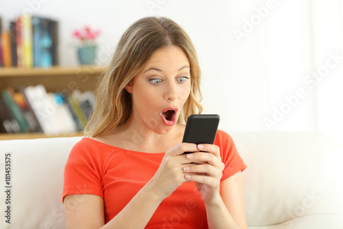 Surprised girl watching smart phone content