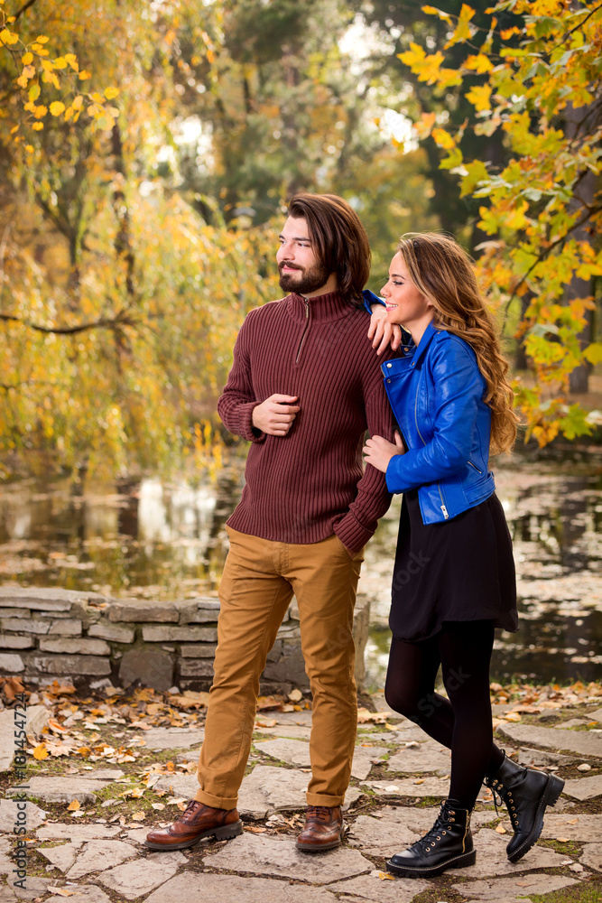 Cute couple in park filled with autumn colors. Cute couple in park filled with autumn colors.