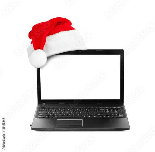 Notebook computer and Santa Claus red christmas hat © Nikolai Sorokin