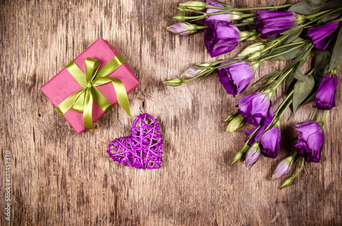 Fototapeta Naklejka Na Ścianę i Meble -  Wicker heart, gift and flowers. Valentine's Day. Romantic gift