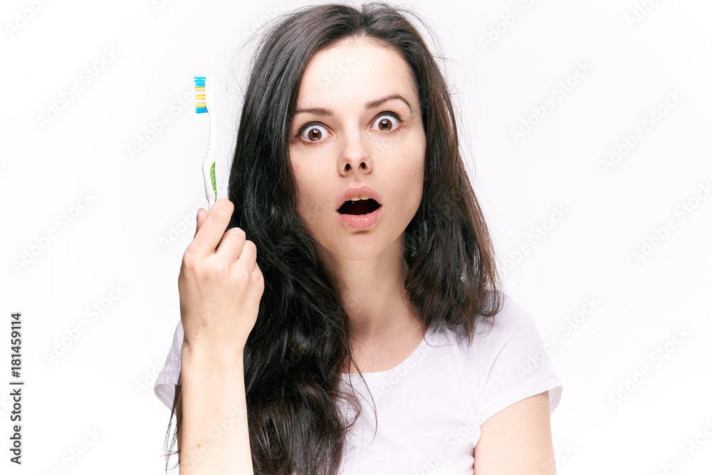 Emotions, surprise, toothbrush, woman on white isolated background, brunette, cleanliness, dental hygiene Emotions, surprise, toothbrush, woman on white isolated background, brunette, cleanliness, dental hygiene