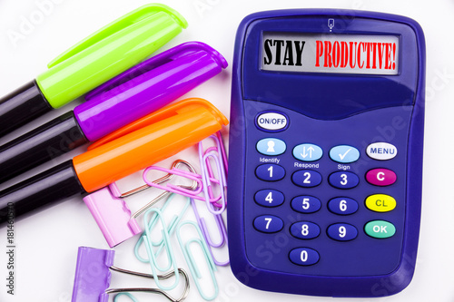 Writing word Stay Productive text in the office with surroundings such as marker, pen writing on calculator Business concept for Concentration Efficiency Productivity white background copy space photo