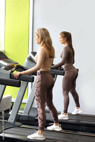 Fitness girls running on treadmill 