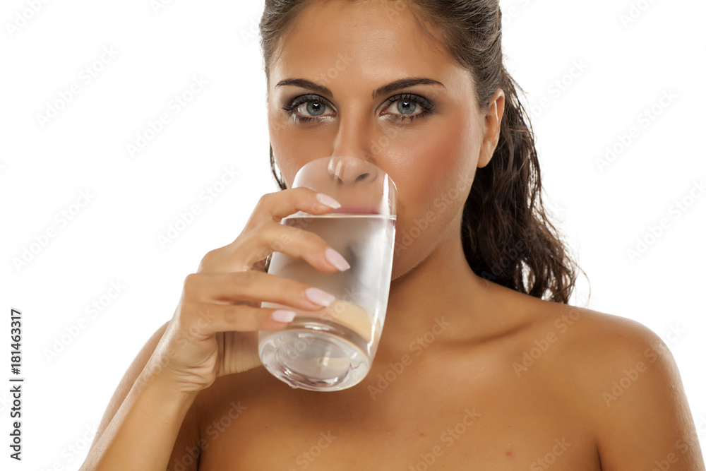 a young woman drinks cold water from the glass a young woman drinks cold water from the glass