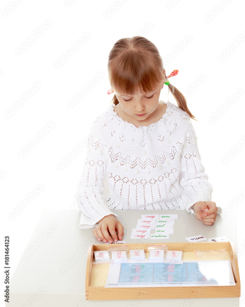 A little girl is studying Montessori stuff. A little girl is studying Montessori stuff.