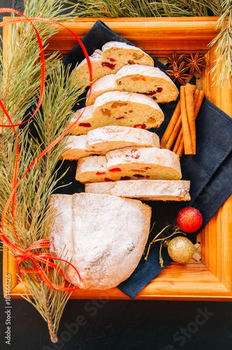 Slices of Dresden Stollen with dried cranberies and nuts. Festive European dessert. Christmas baking concept. Top view. photo