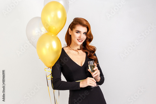 Party portrait of glamour elegant woman with champagne and golden ballons isolated. New year seledration.