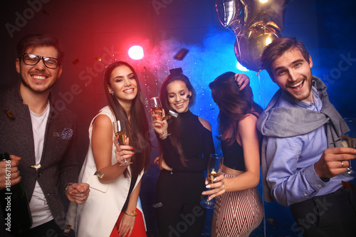 new year party, holidays, celebration, nightlife and people concept - Young people having fun dancing at a party