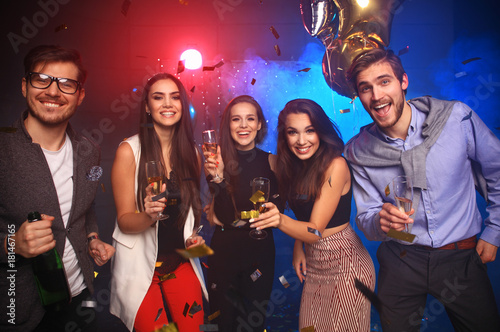 new year party, holidays, celebration, nightlife and people concept - Young people having fun dancing at a party