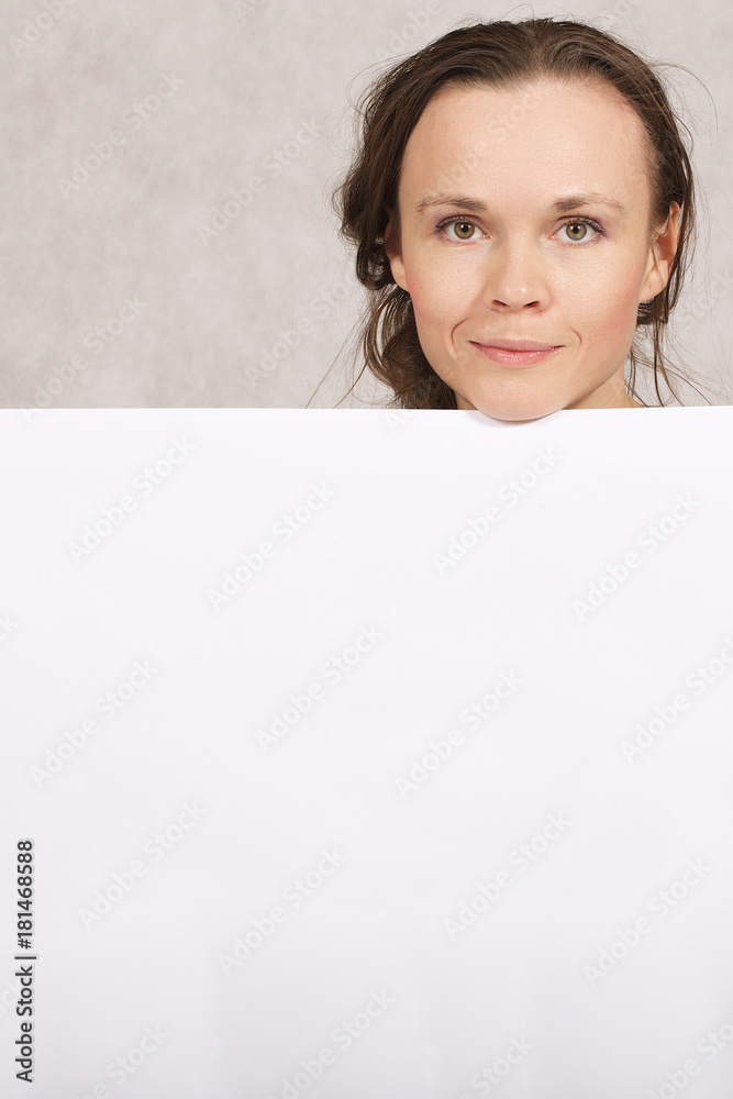 Young lady keeps a white sheet of paper Young lady keeps a white sheet of paper