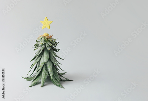 Christmas tree made of pineapple leaves and christmas decoration. Holiday concept.