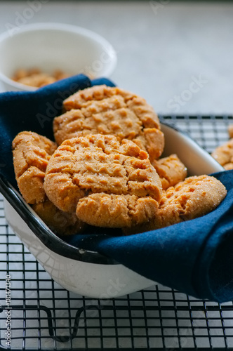 Homemade peanut butter cookies on a wire rack. Gray background. Rustic style.