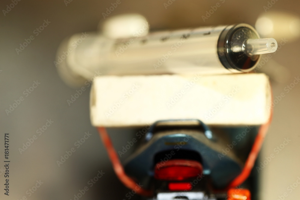 Backside of motorcycle plastic model carry old syringe. Backside of motorcycle plastic model carry old syringe.